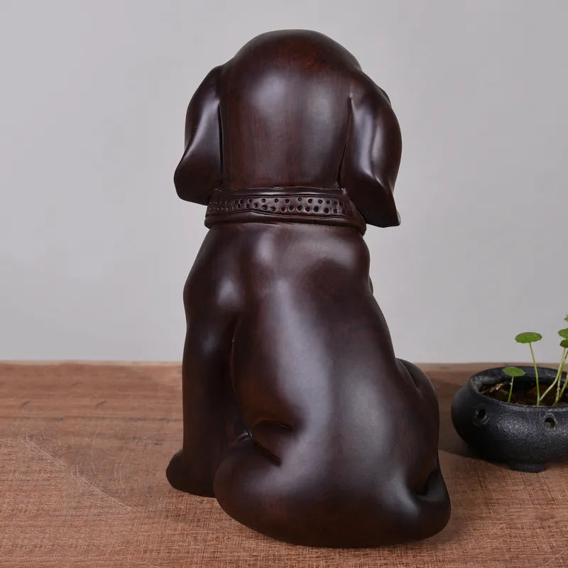 Wood-carved dog ornaments, made of solid ebony wood, the dog of the Chinese zodiac. They are cute home decoration items and handicrafts made of mahogany.